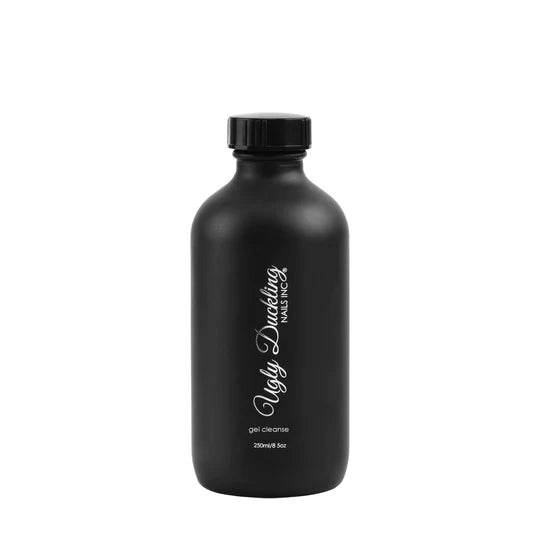 Ugly Duckling GEL CLEANSE liquid in a 250ml black glass bottle, showcasing the product's sleek packaging and gel texture.