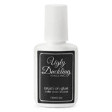 Ugly Duckling brush-on glue from Odds & Ends collection, showing the clear liquid adhesive in a small applicator bottle.