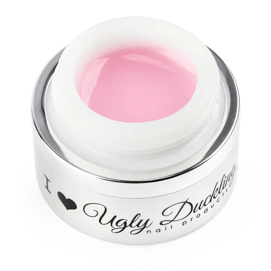Pink sculpting builder gel from Ugly Duckling, shown in a close-up image highlighting its smooth, pink consistency for nail enhancement.
