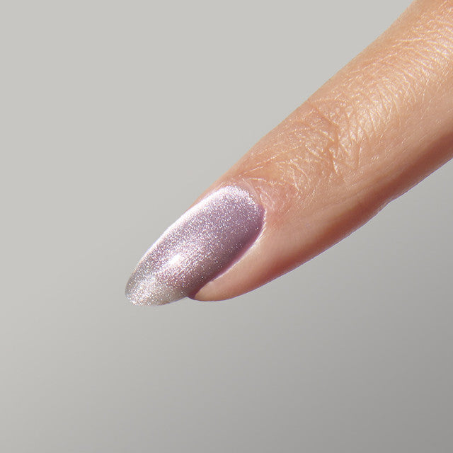 Close-up of a hand with manicured nails using the CHILL Magnetic Gel Polish by the GEL bottle, showcasing the gel polish's magnetic effect.