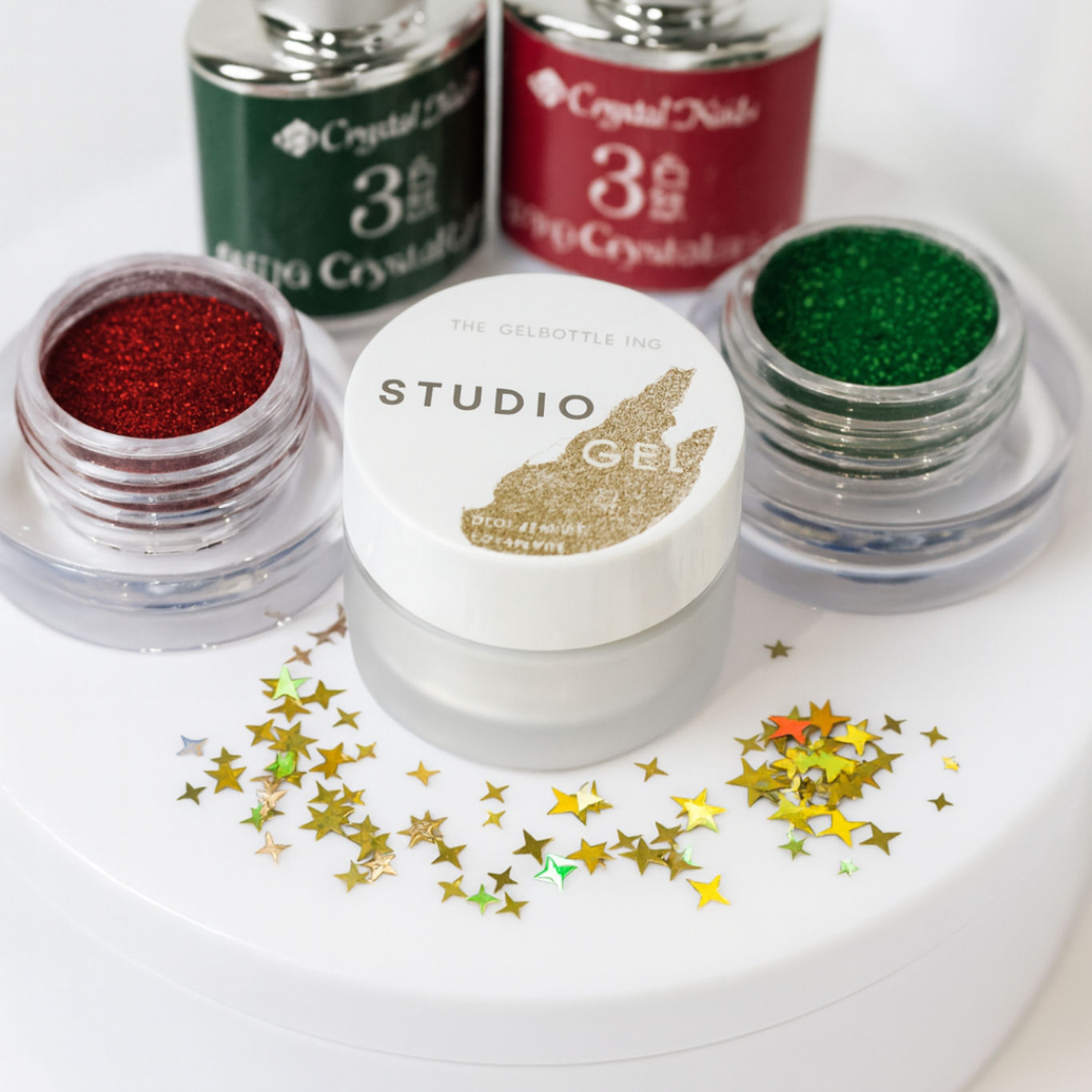 Set of Studio Gel nail polish bottles with glittery finishes on a white background