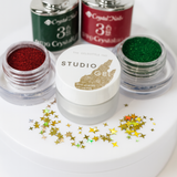 Set of Studio Gel nail polish bottles with glittery finishes on a white background