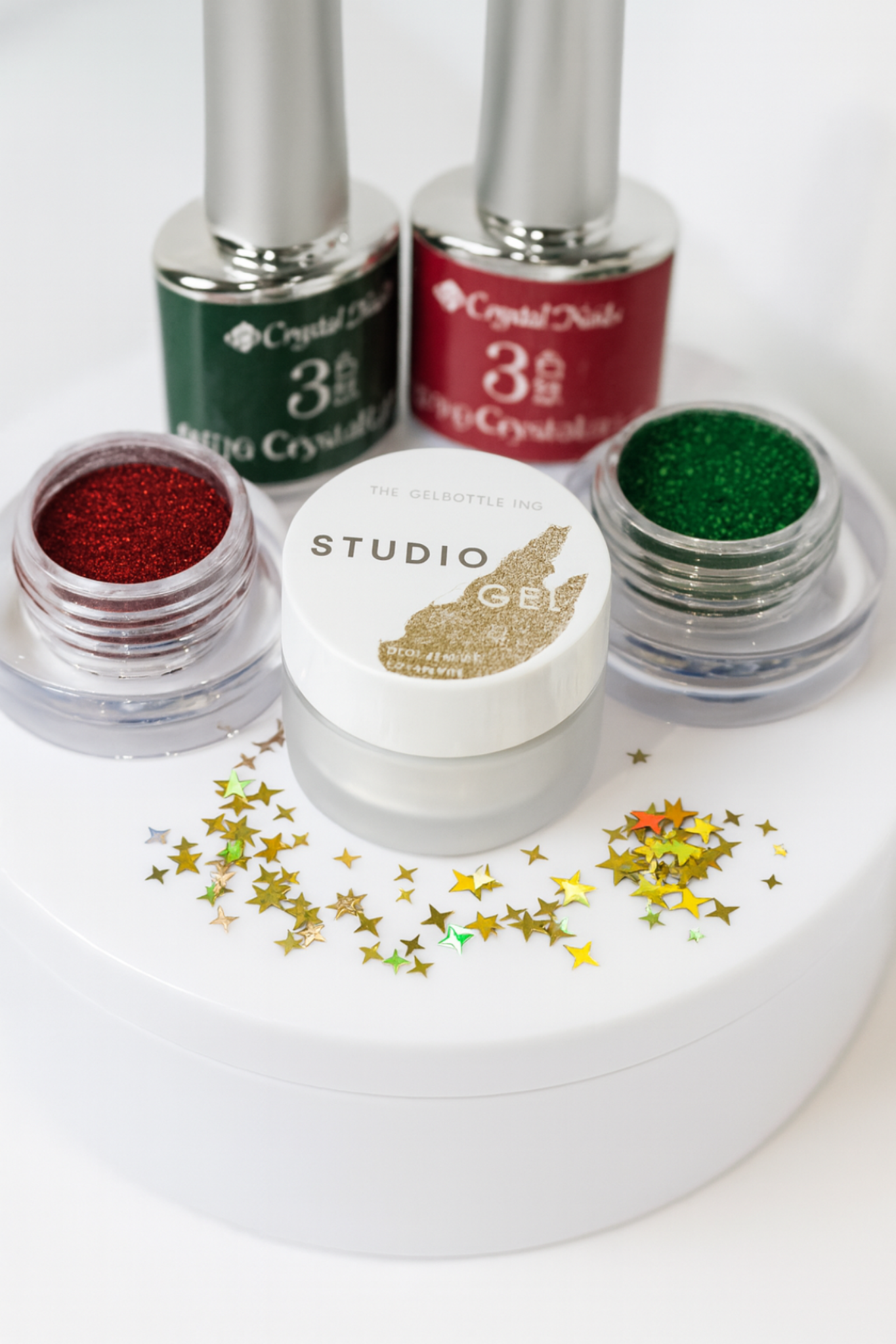 Set of Studio Gel nail polish bottles with glittery finishes on a white background